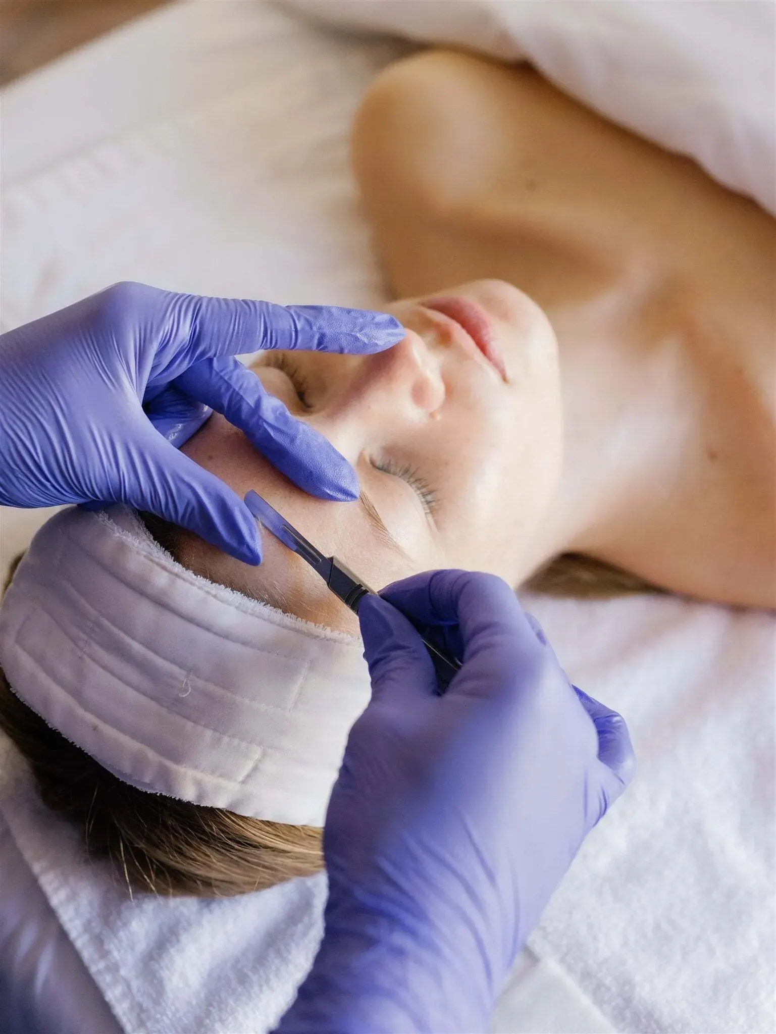 Sterile single-use dermaplaning blade and prepped skin during a dermaplane facial in Crescent Springs KY